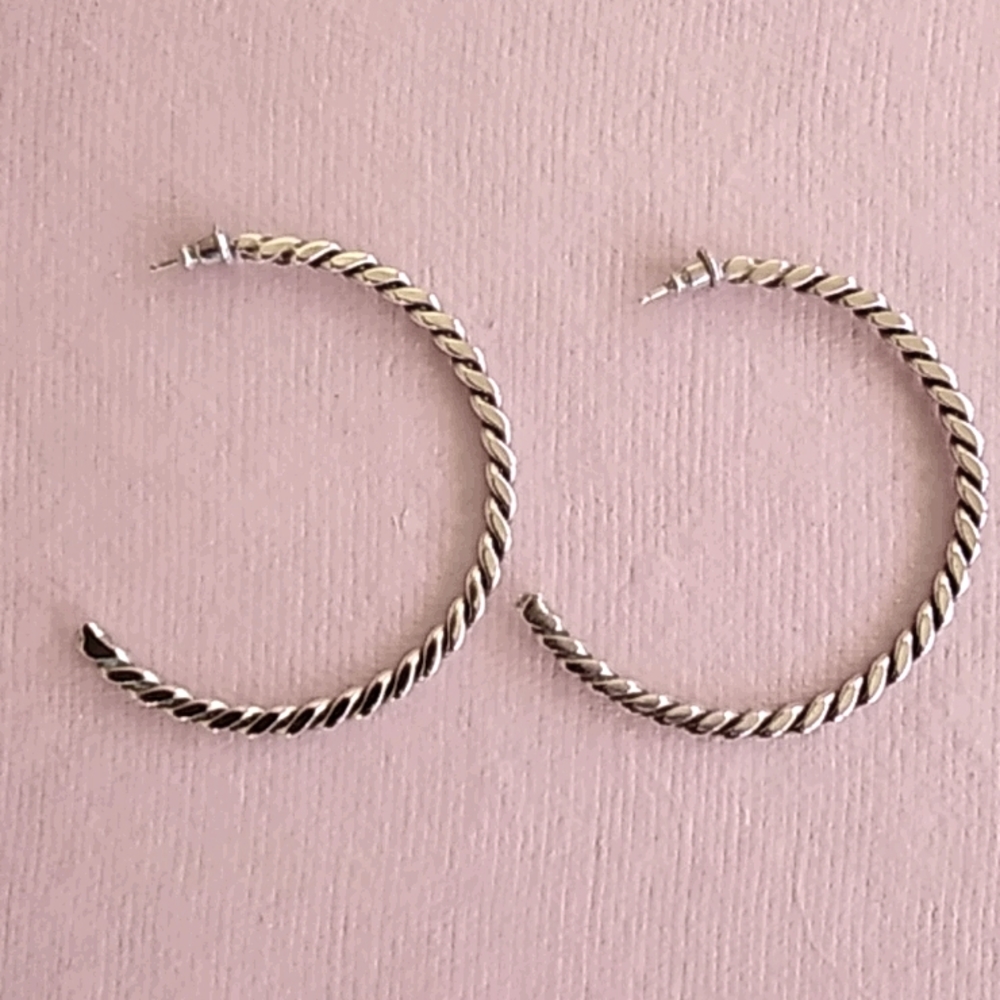 Native American crafted silver hoop earrings.